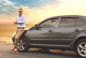 Guy leaning on a car