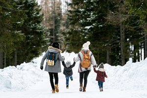 Family walking on a snowy road